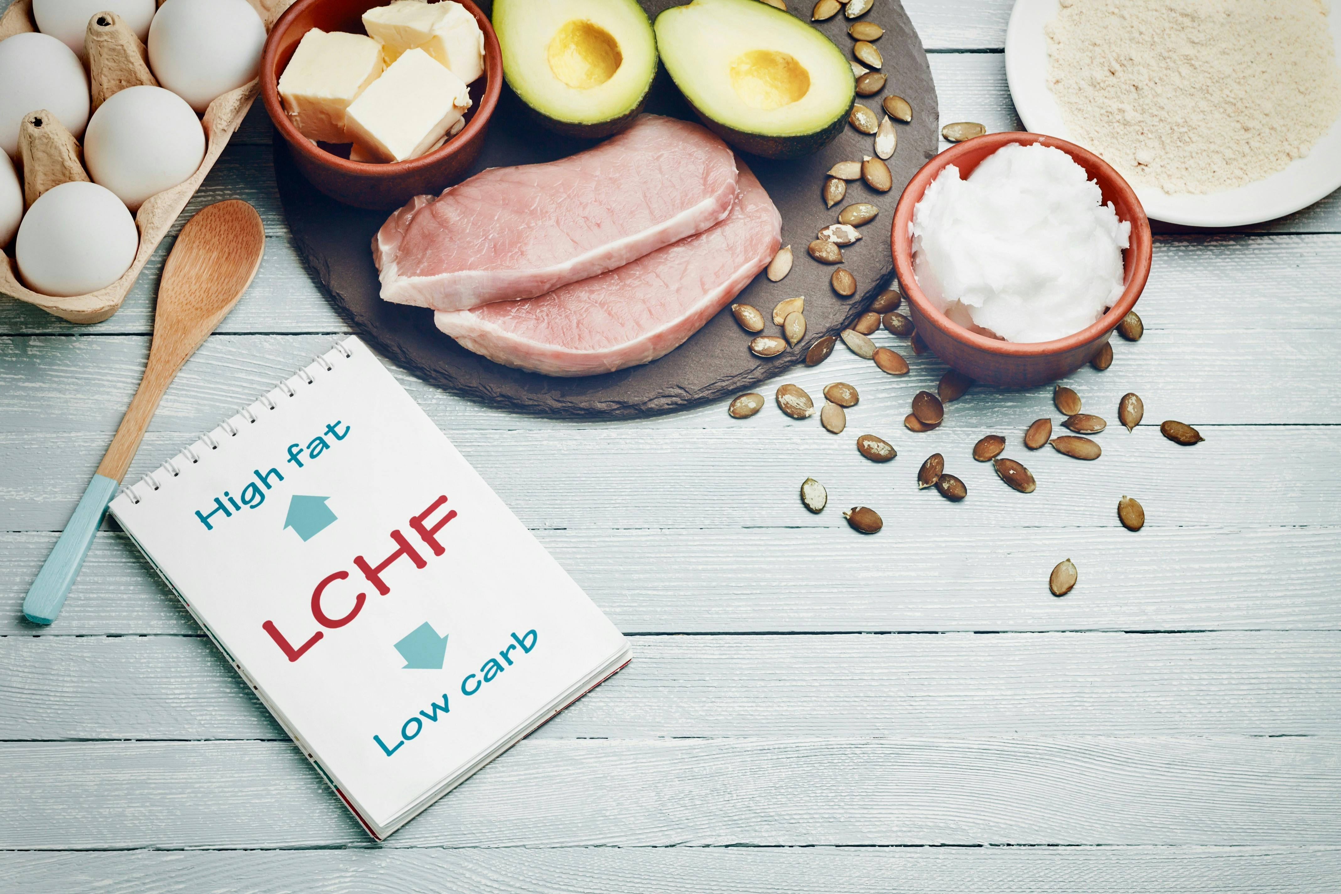 Notepad and dietary food on light table.